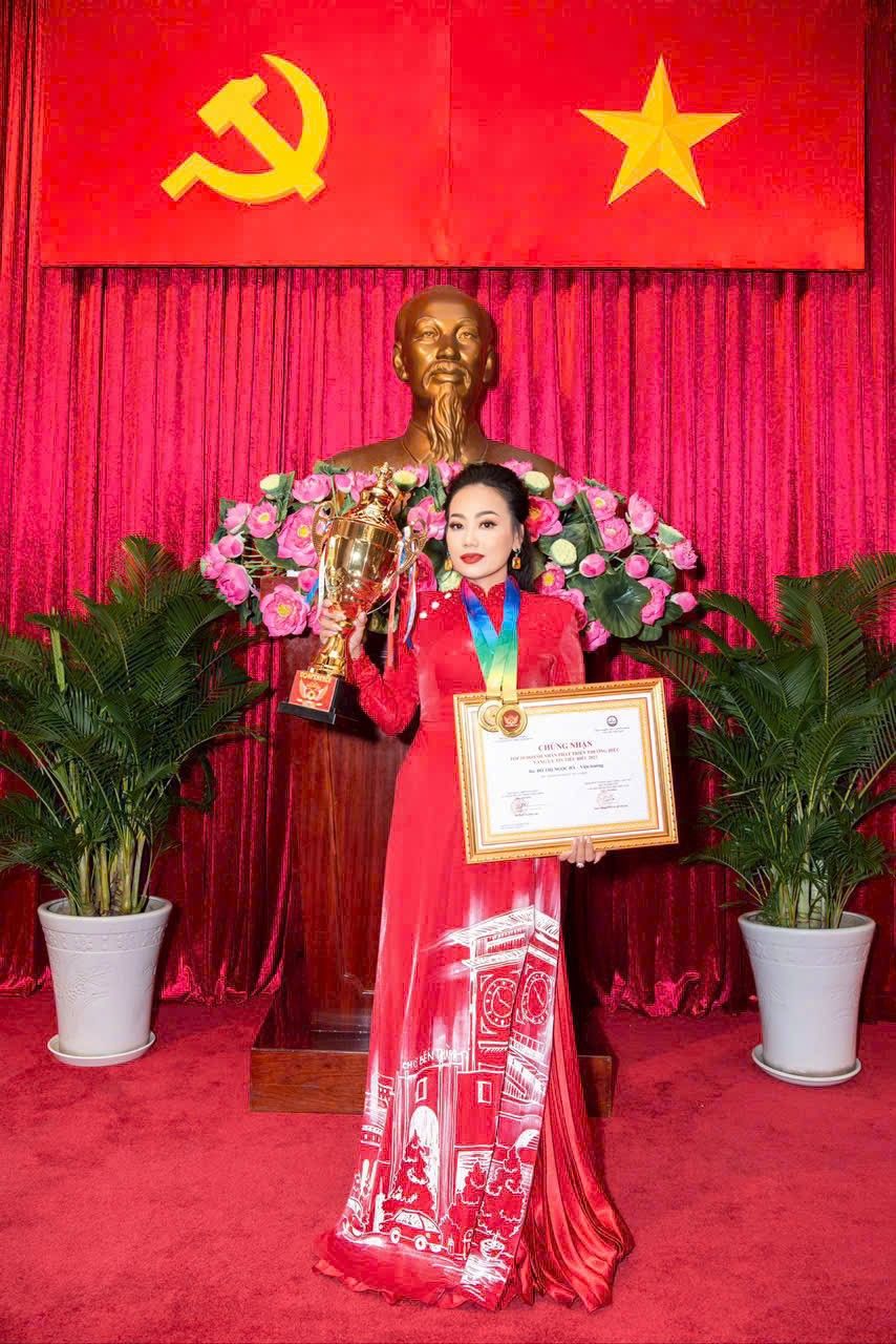 A person holding a trophy and a trophyAI-generated content may be incorrect.